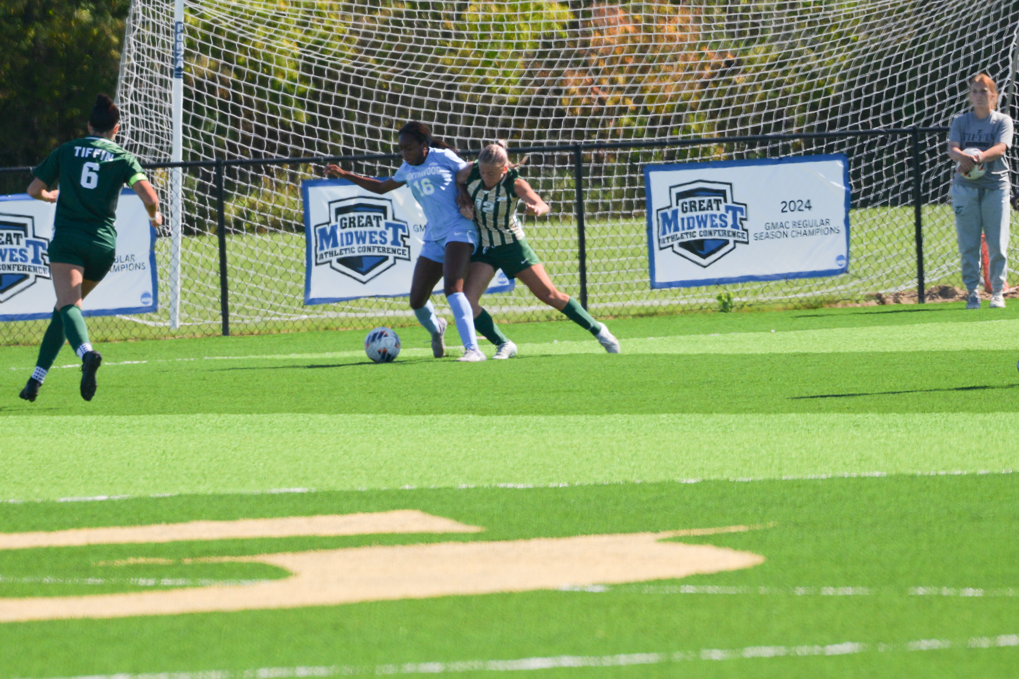 Mari Jackson shielding the ball near GMAC championship signage